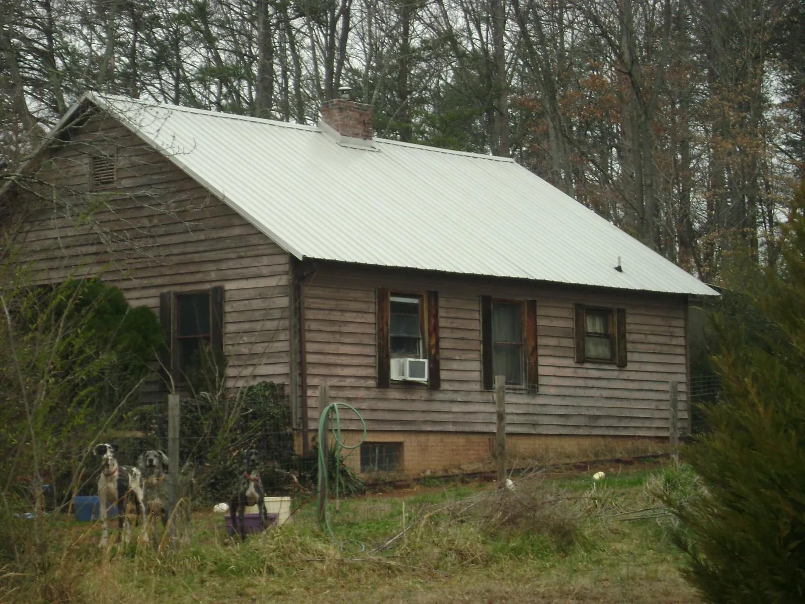 White metal roof on an old wood sided farmhouse, from a Metal Roof Installation job in New Suffolk